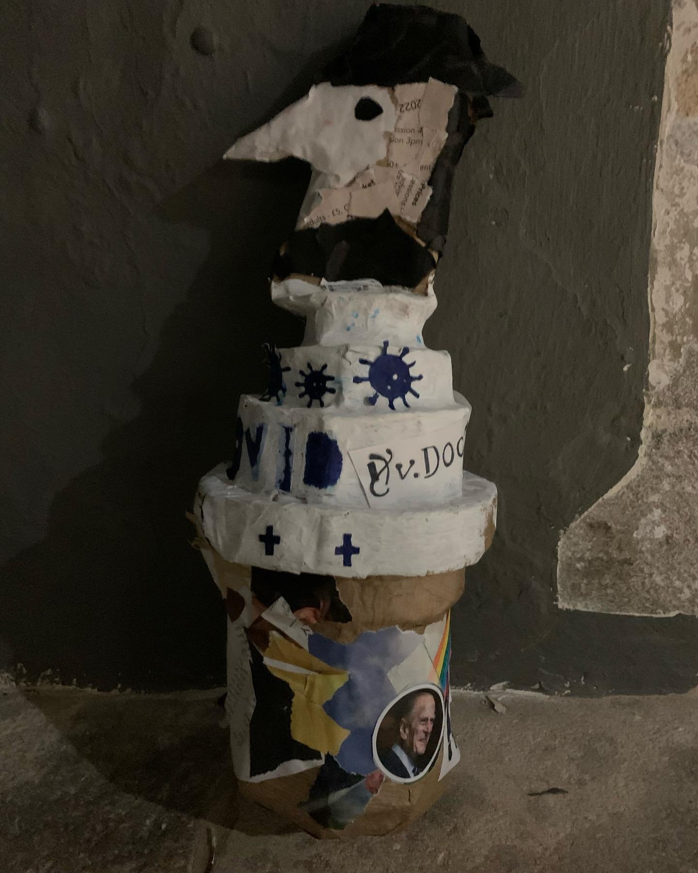 A papier-mâché plague doctor sculpture made by participants during a Lockarts community workshop, decorated with collaged paper and painted virus motifs.