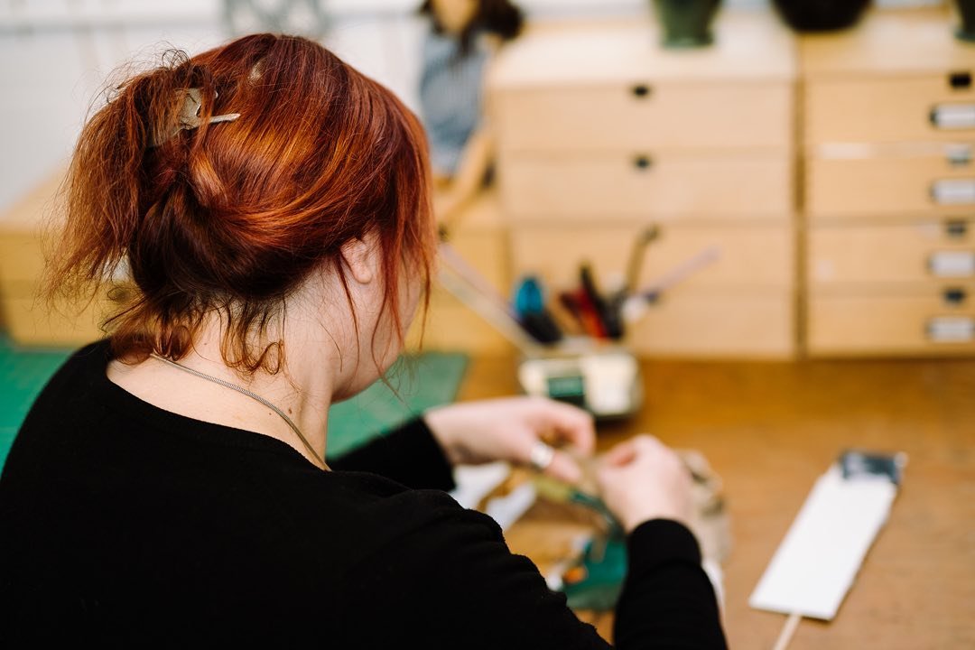 A participant working quietly at a studio bench during a Lockarts therapeutic arts session.